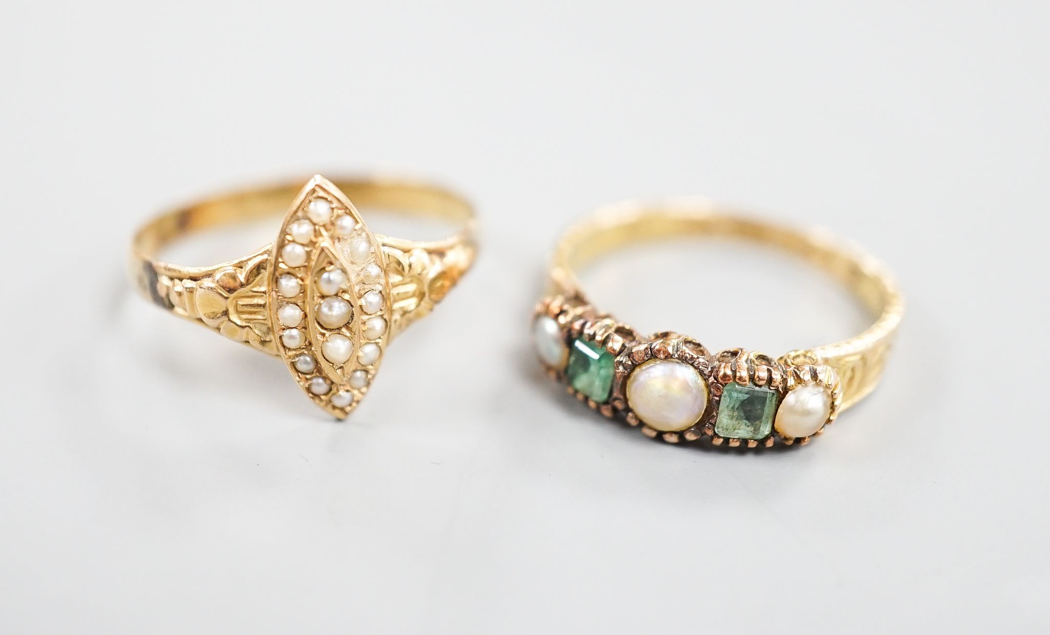 A Victorian 15ct gold, emerald and split pearl set five stone half hoop ring, size M, gross 1.9 grams and an early 20th century yellow metal and seed pearl set dress ring, size O, gross 1.7 grams.